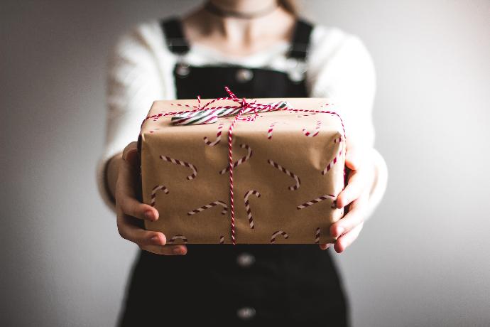 person showing brown gift box